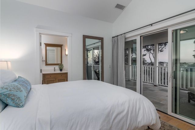 a bedroom with a large bed and a chandelier