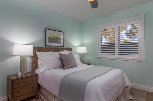 a bedroom with a bed and window