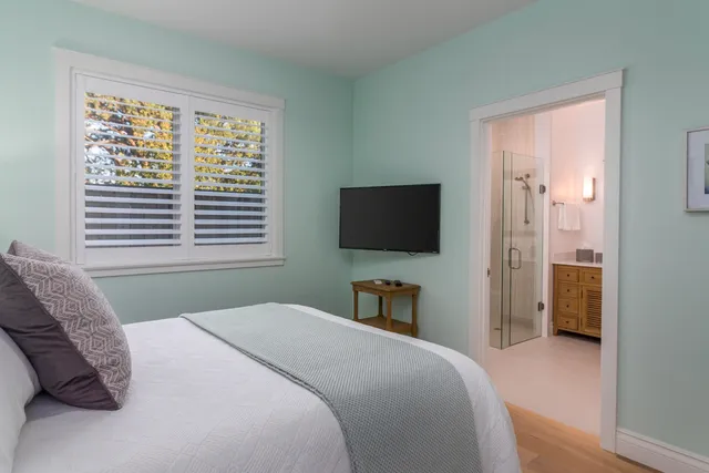 a bedroom with a bed and a flat screen tv