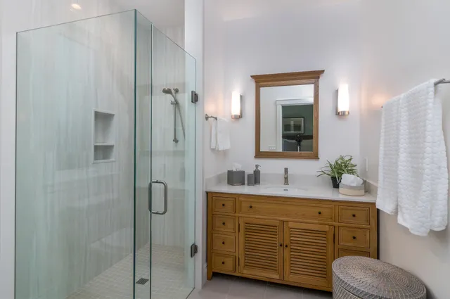 a bathroom with a double vanity sink mirror and shower