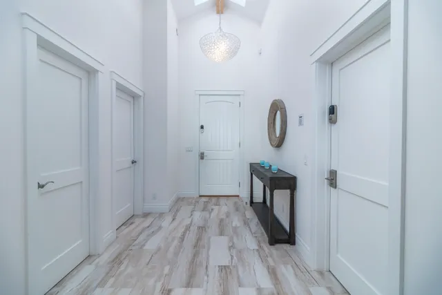 a walk in closet with wooden floor