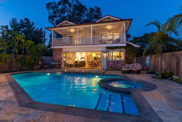a view of a house with backyard and sitting area