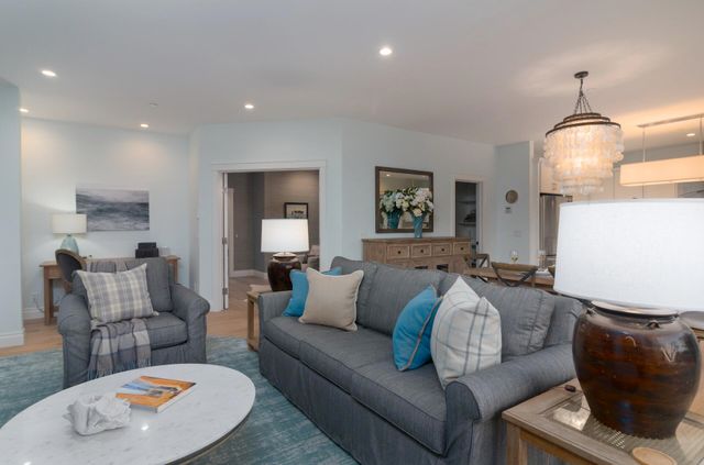 a living room with furniture and a lamp