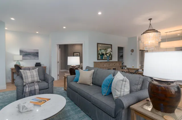 a living room with furniture and a lamp