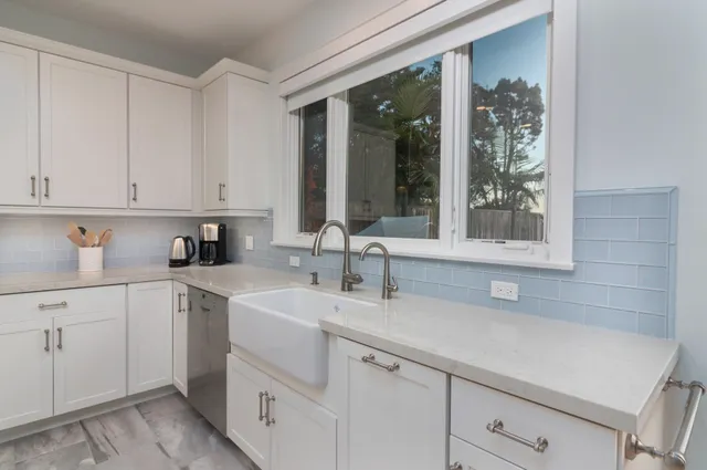 a kitchen with a sink cabinets and window