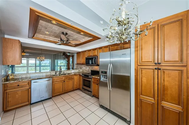 an empty room with a ceiling fan and wooden floor
