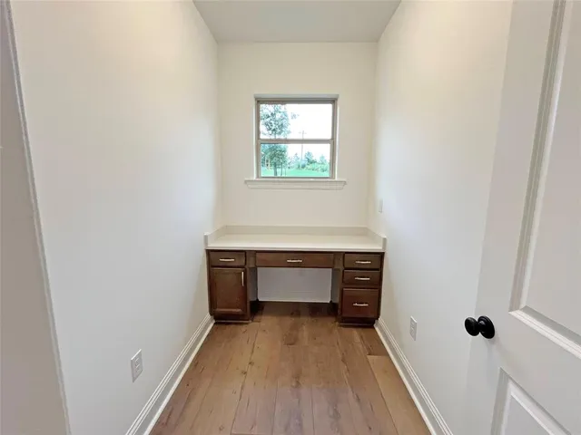 wooden floor in an empty room and a window