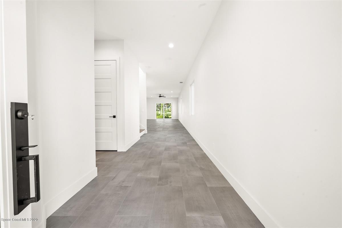 2168 Country Club Road Melbourne, FL 32901 - Photo 4 of 94 a view of a hallway with wooden floor
