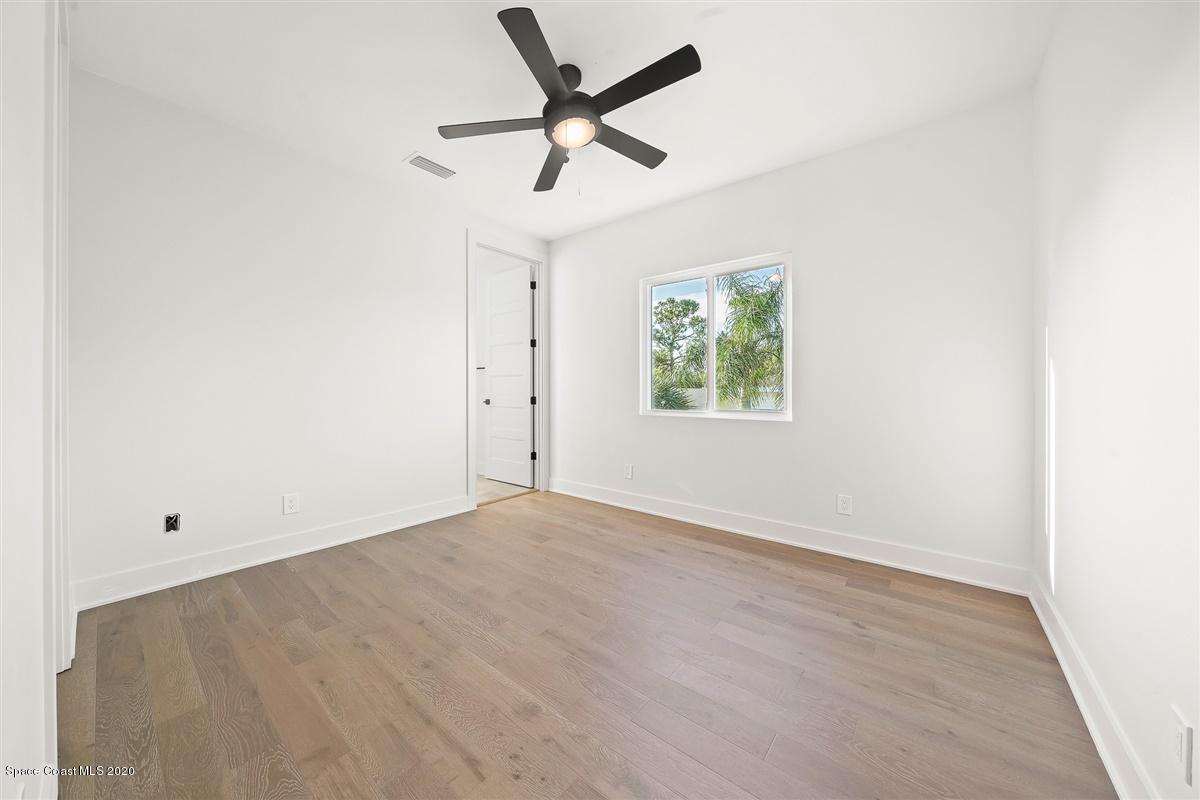 2168 Country Club Road Melbourne, FL 32901 - Photo 56 of 94 an empty room with ceiling fan and window