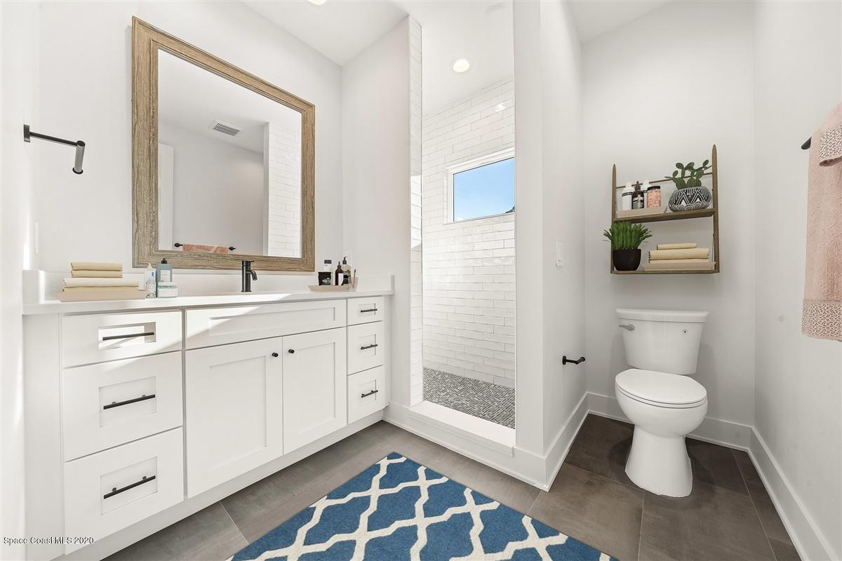 2168 Country Club Road Melbourne, FL 32901 - Photo 58 of 94 a bathroom with a double vanity sink toilet and shower