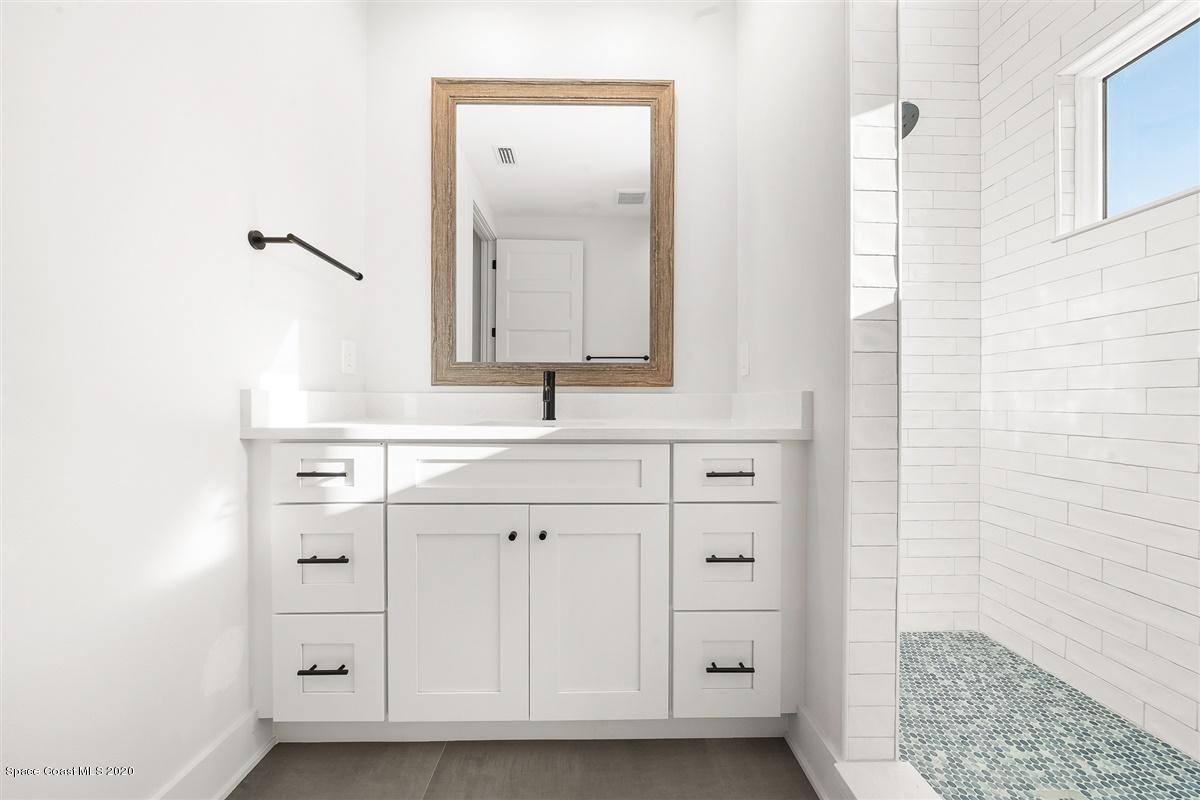 2168 Country Club Road Melbourne, FL 32901 - Photo 61 of 94 a bathroom with a sink and a mirror