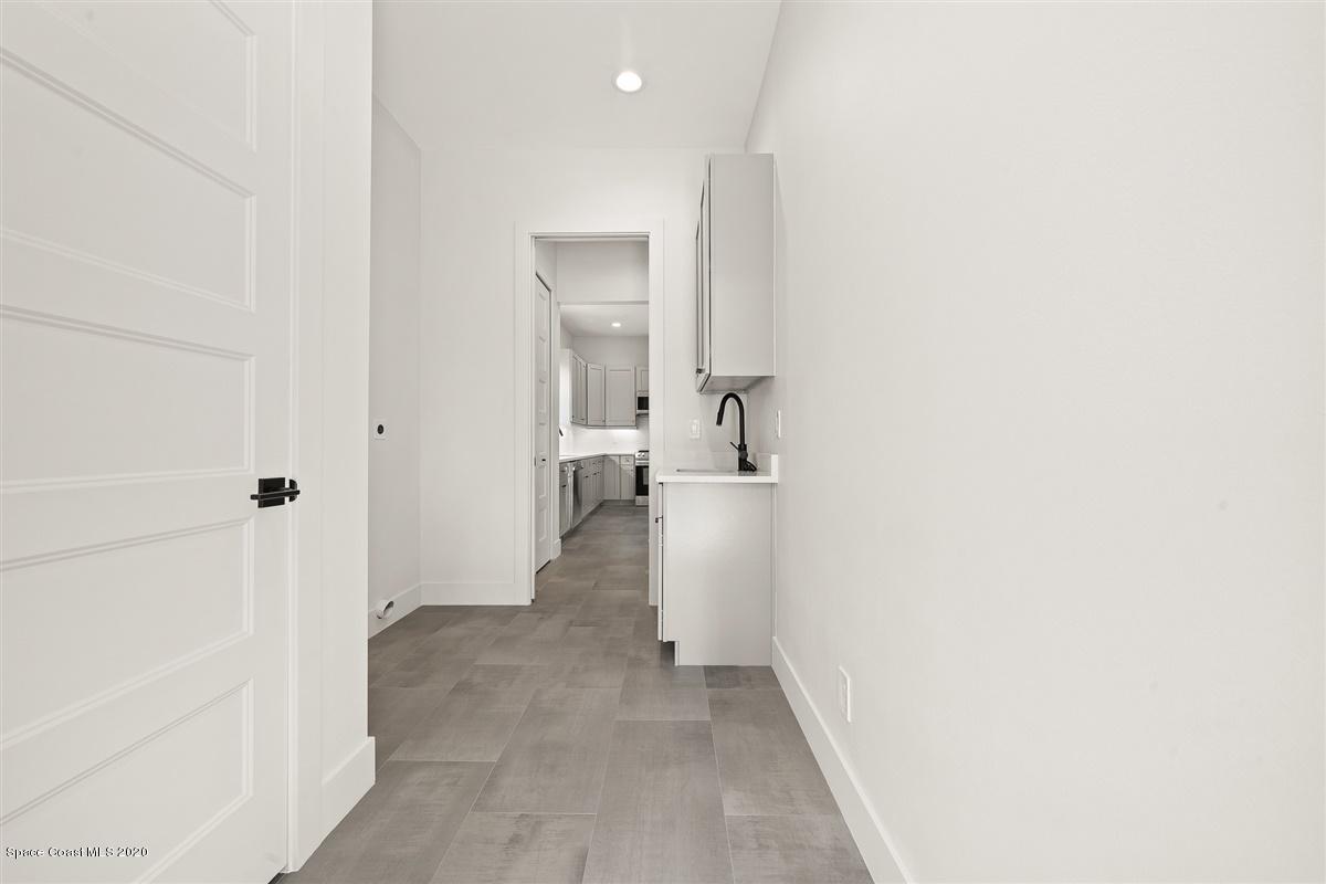 2168 Country Club Road Melbourne, FL 32901 - Photo 62 of 94 a view of a bathroom with a hallway