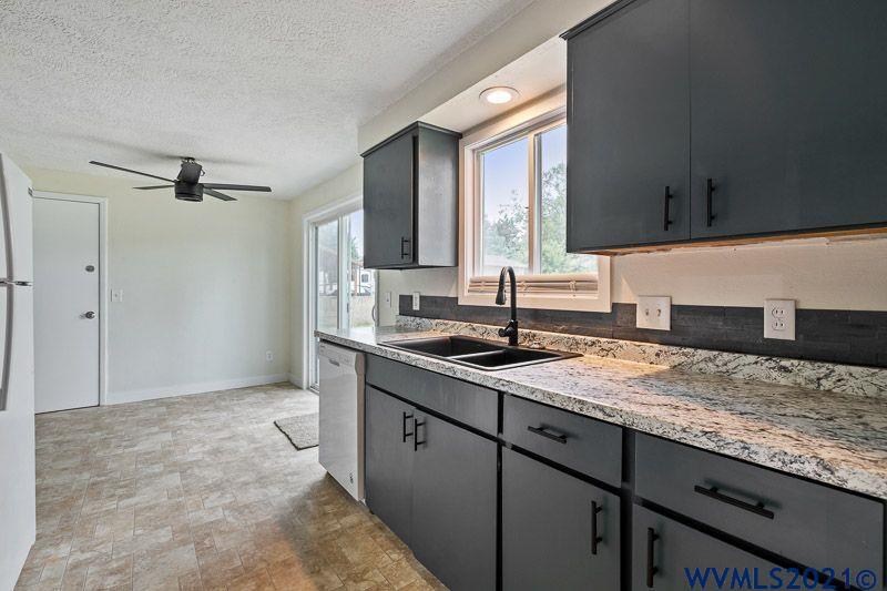 1121 Fabry Road Southeast Salem, OR 97306 - Photo 16 of 31 a kitchen with a sink stove and cabinets