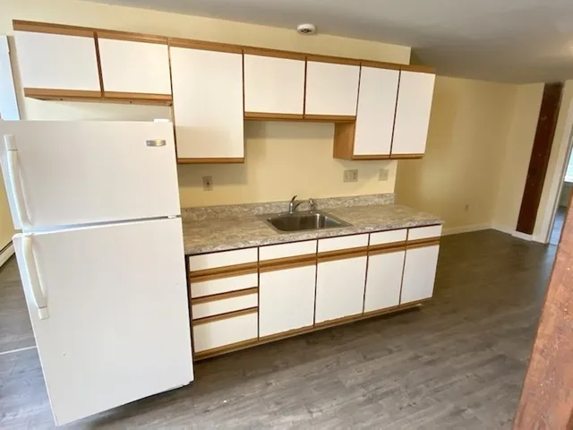 a kitchen with a refrigerator a stove a microwave and cabinets