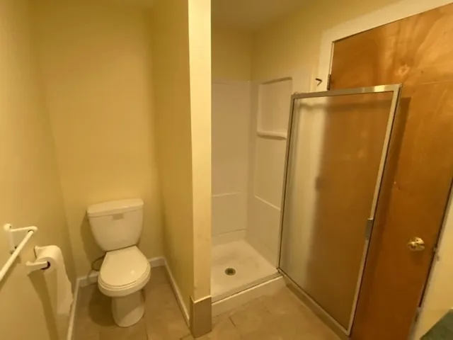 a bathroom with a toilet and shower