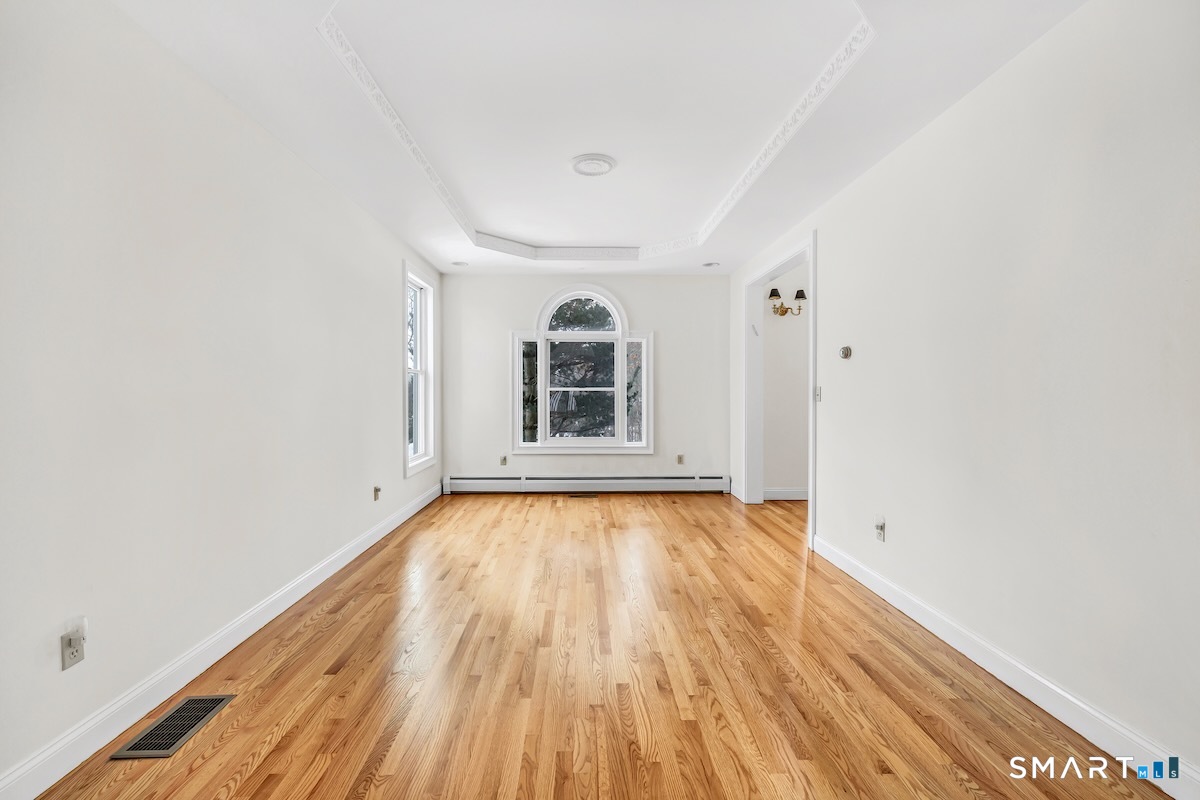 461 Amity Road Woodbridge, CT 06525 - Photo 11 of 40 a view of empty room with wooden floor and fan