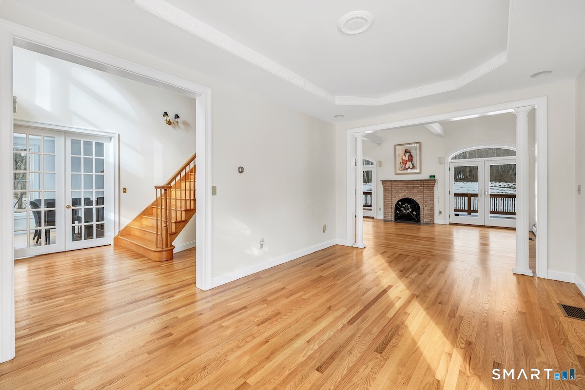 461 Amity Road Woodbridge, CT 06525 - Photo 13 of 40 a view of empty room with fireplace and wooden floor