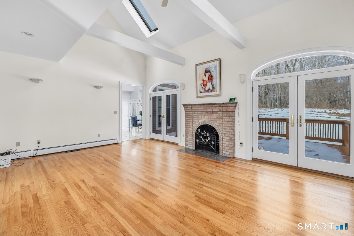 461 Amity Road Woodbridge, CT 06525 - Photo 14 of 40 a view of empty room with fireplace and wooden floor