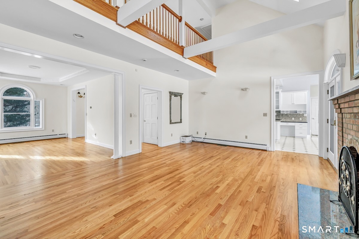 461 Amity Road Woodbridge, CT 06525 - Photo 15 of 40 a view of empty room with wooden floor and windows