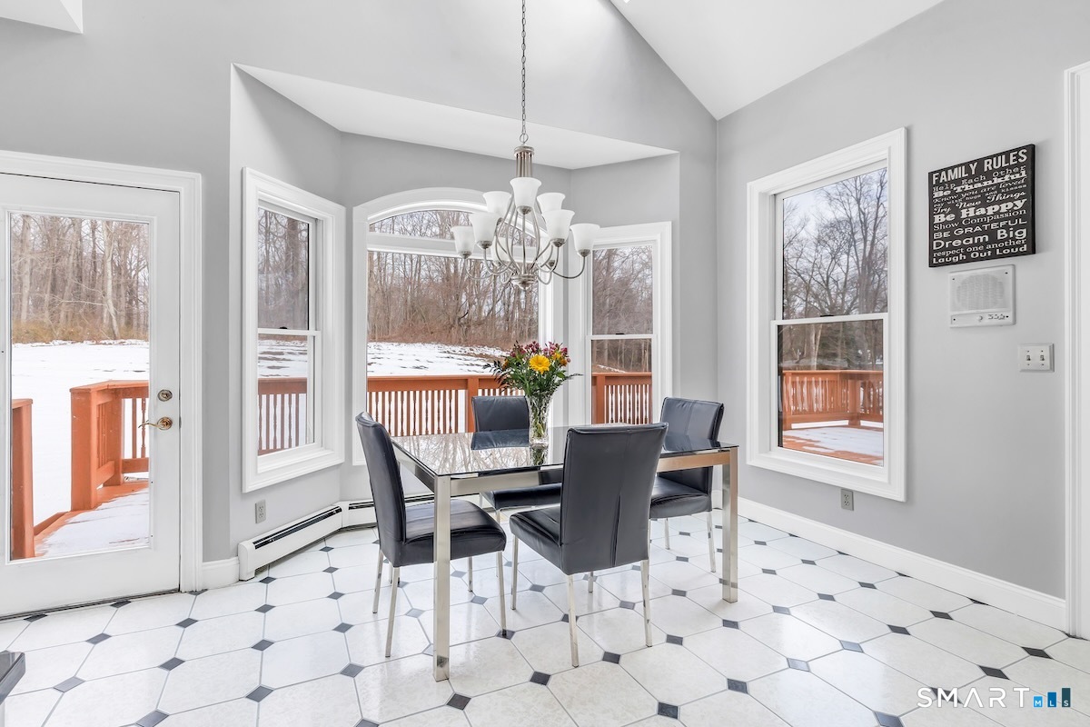 461 Amity Road Woodbridge, CT 06525 - Photo 16 of 40 a view of a dining room with furniture wooden floor and chandelier