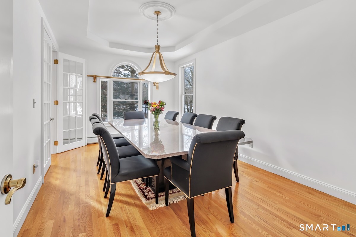 461 Amity Road Woodbridge, CT 06525 - Photo 20 of 40 a view of a dining room with furniture window and wooden floor