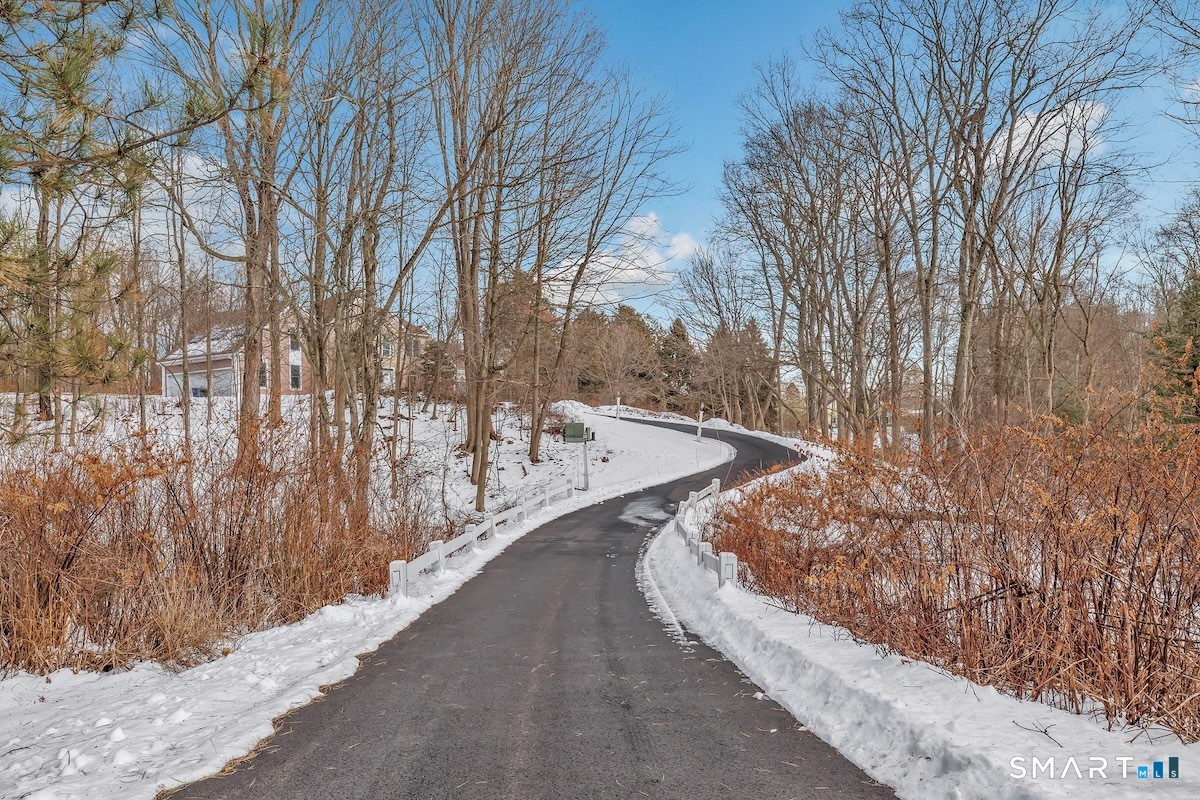 461 Amity Road Woodbridge, CT 06525 - Photo 2 of 40 a view of a pathway with a wrought fence