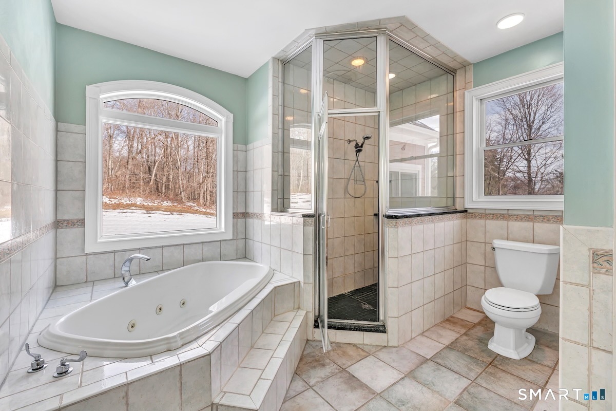 461 Amity Road Woodbridge, CT 06525 - Photo 23 of 40 a bathroom with a bathtub and a shower