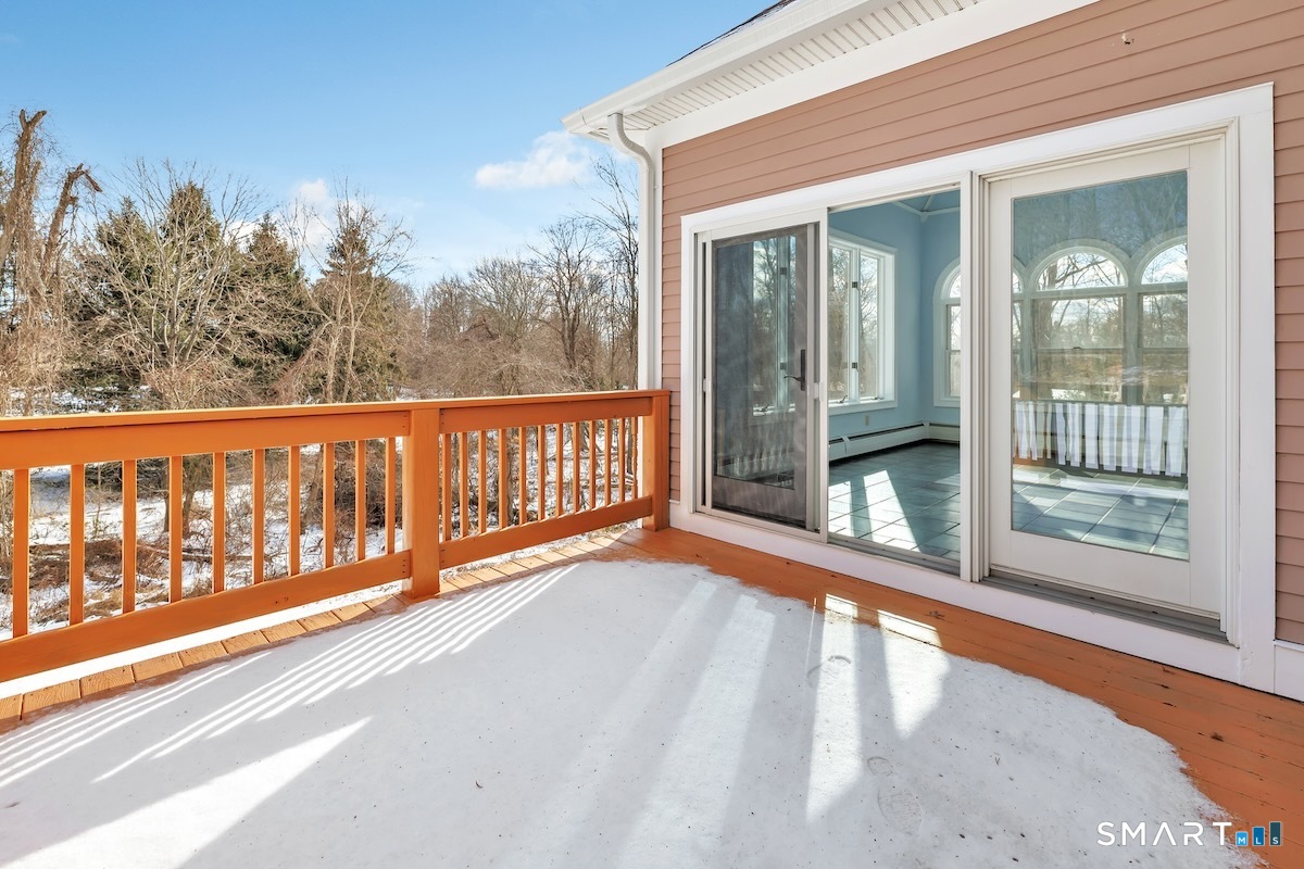 461 Amity Road Woodbridge, CT 06525 - Photo 26 of 40 a view of a roof deck with wooden floor and fence