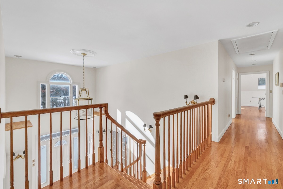 461 Amity Road Woodbridge, CT 06525 - Photo 29 of 40 a view of a hallway with wooden floor and windows