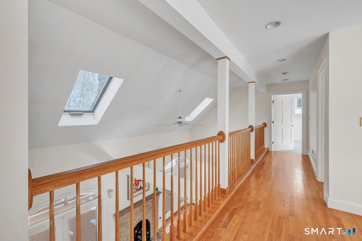 461 Amity Road Woodbridge, CT 06525 - Photo 31 of 40 a view of a hallway with wooden floor