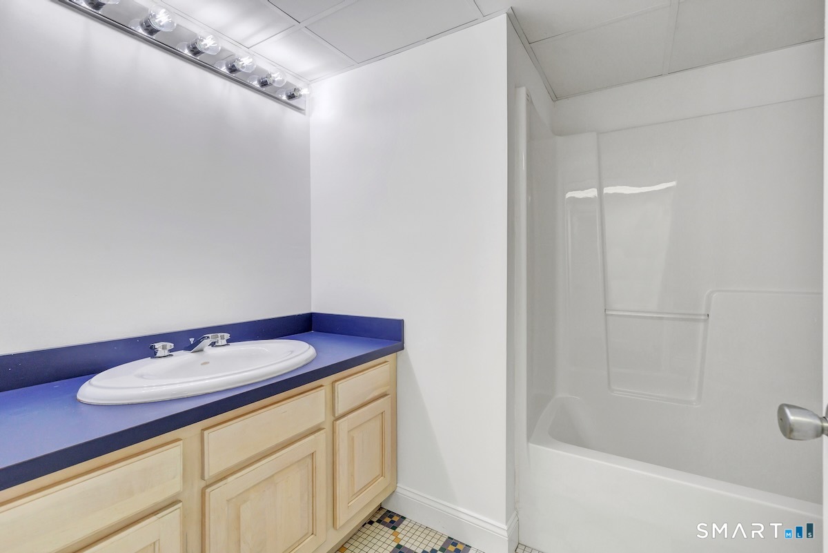 461 Amity Road Woodbridge, CT 06525 - Photo 37 of 40 a bathroom with a sink and a mirror