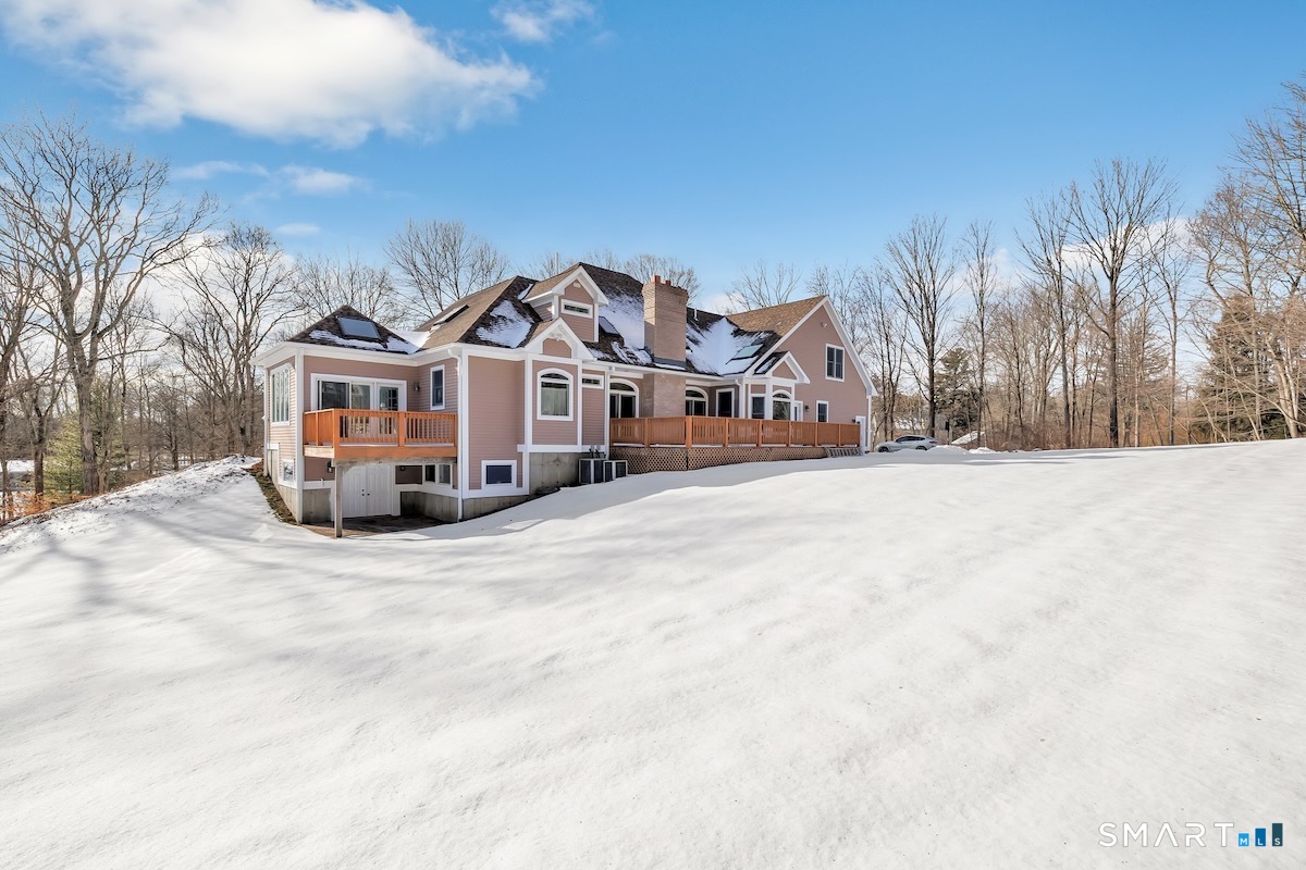 461 Amity Road Woodbridge, CT 06525 - Photo 6 of 40 a view of a white house with a yard covered in snow