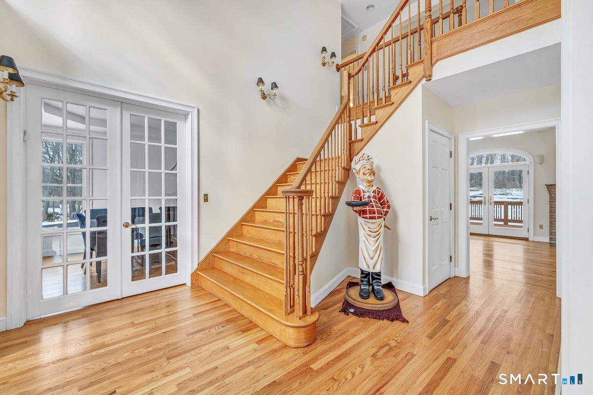 461 Amity Road Woodbridge, CT 06525 - Photo 10 of 40 a view of entryway with wooden floor and stairs