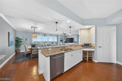 a large kitchen with cabinets and wooden floor