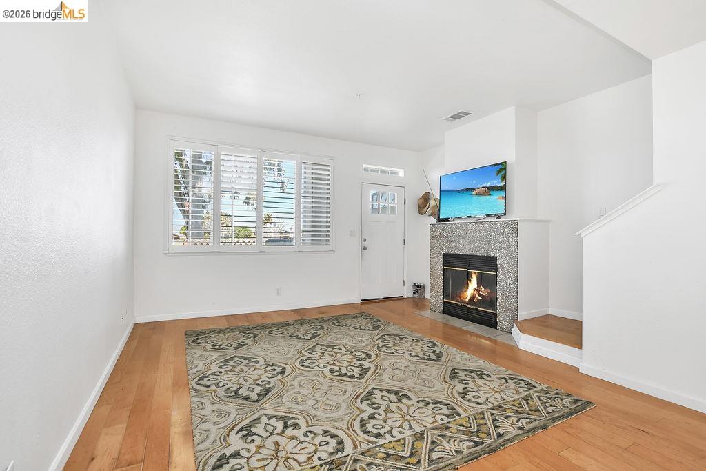 3487 Wells Road Oakley, CA 94561 - Photo 14 of 30 Living area featuring a tiled fireplace and light wood finished floors