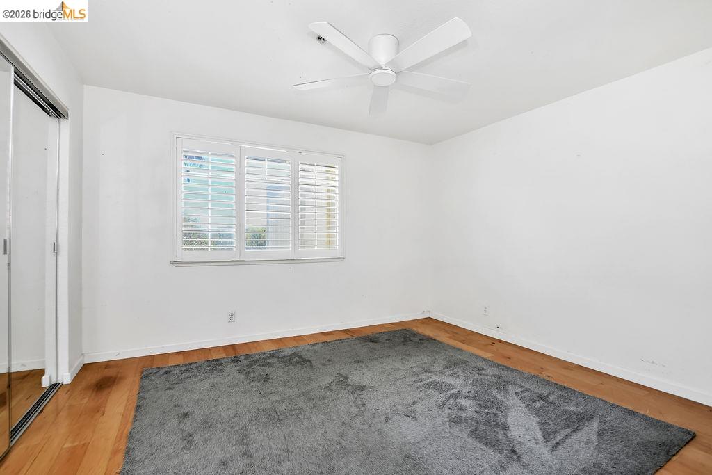 3487 Wells Road Oakley, CA 94561 - Photo 19 of 30 Unfurnished bedroom with a closet, wood finished floors, and a ceiling fan