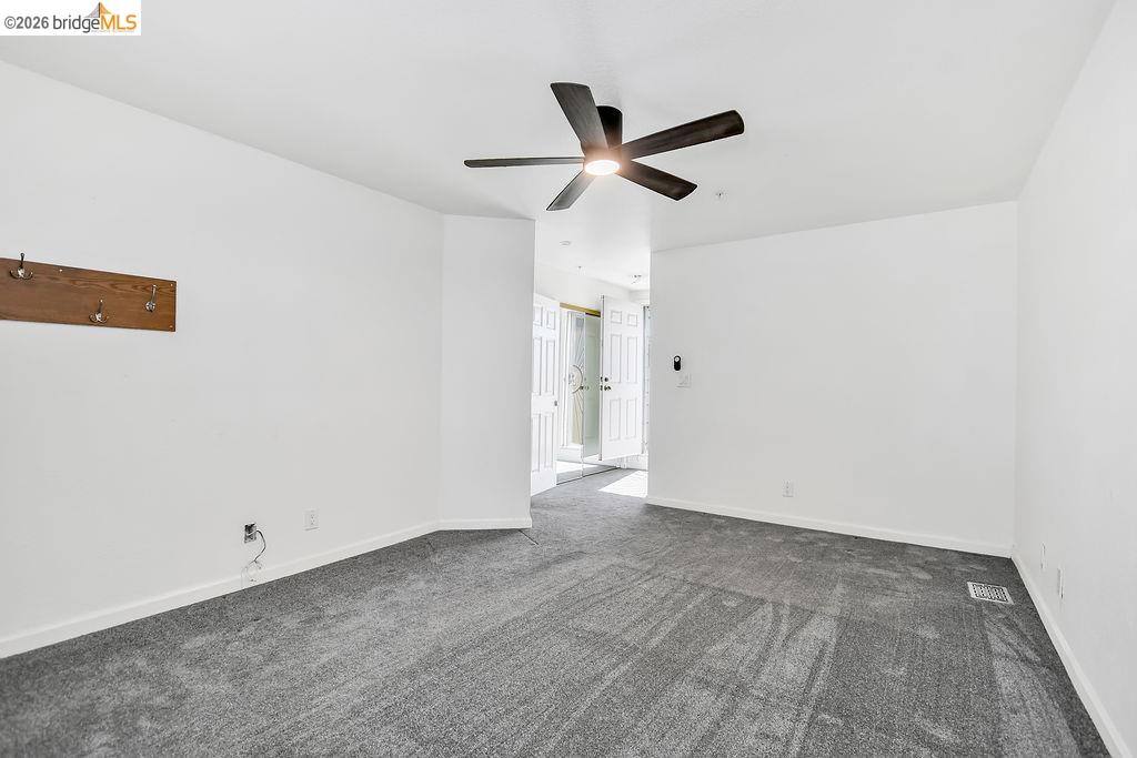 3487 Wells Road Oakley, CA 94561 - Photo 23 of 30 Unfurnished room with dark colored carpet and ceiling fan