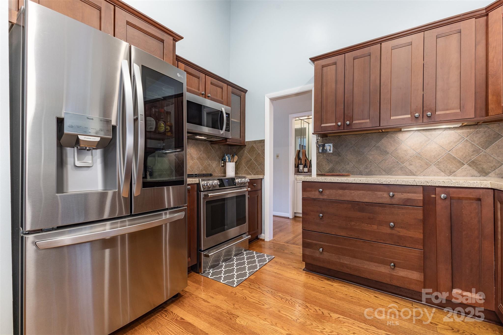 100 Fairway Ridge Clover, SC 29710 - Photo 30 of 45 a kitchen with granite countertop stainless steel appliances and wooden cabinets