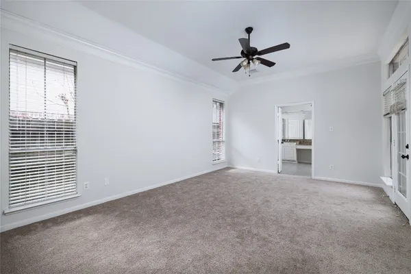 a view of a livingroom with a ceiling fan and window