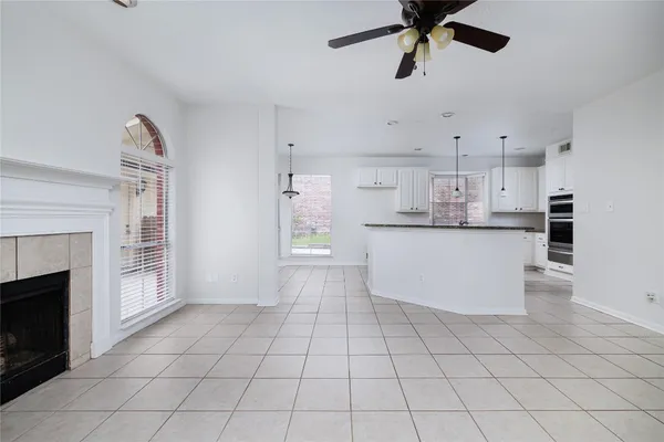 a kitchen with stainless steel appliances a cabinets and a fireplace