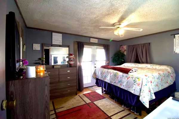 a bedroom with a bed and a mirror on the dresser