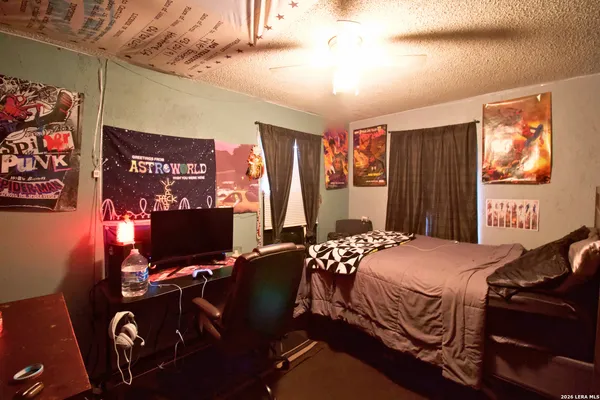 a bedroom with a bed and a desk