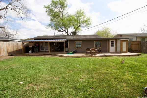 a front view of house with yard and outdoor seating