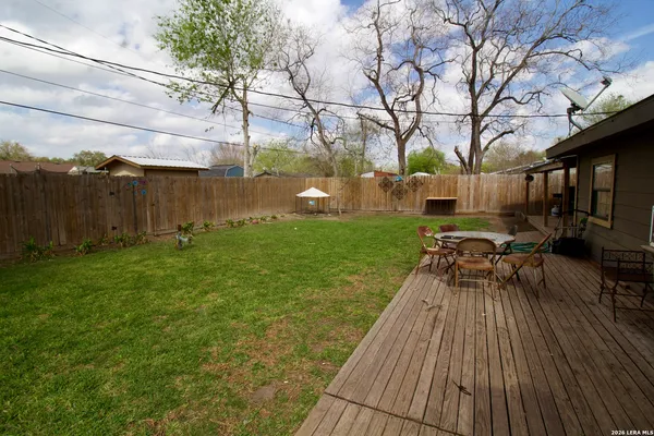 a backyard of a house with table and chairs