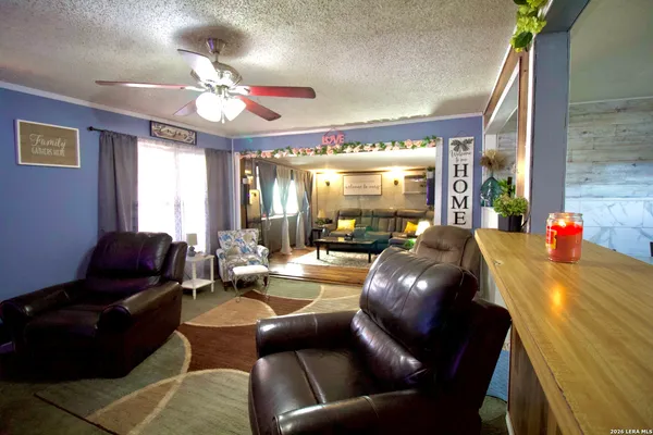 a living room with furniture and a chandelier