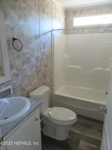 a bathroom with a toilet sink and shower