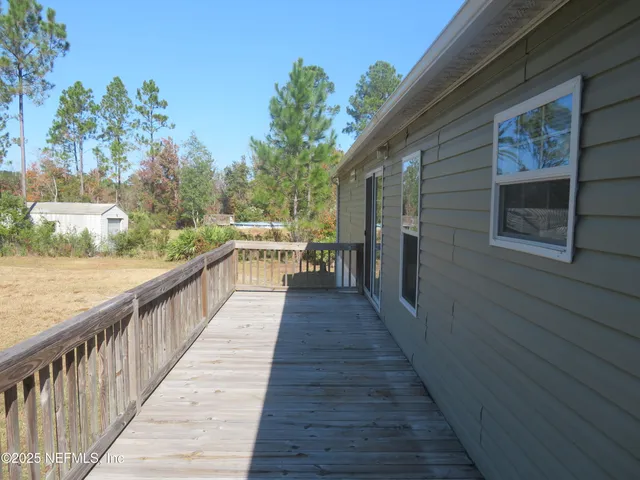 a view of a house with wooden deck