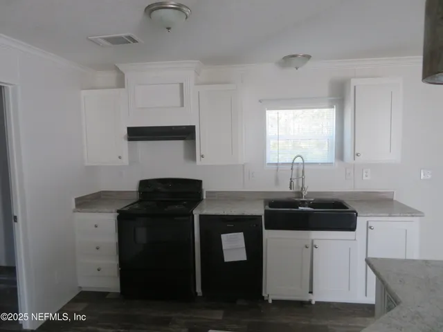 a kitchen with cabinets and appliances