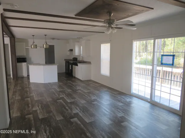 a view of a room with wooden floor and staircase