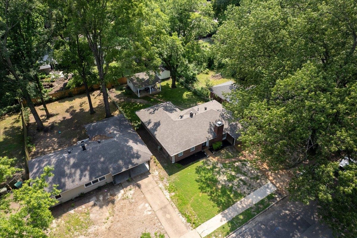 4491 Garnett Road Memphis, TN 38117 - Photo 30 of 32 Single-story residence featuring a gray shingled roof and a brick chimney